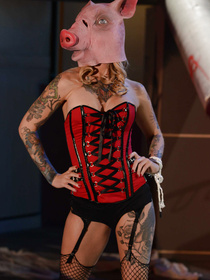 This corset-wearing hottie is rocking a pig mask at first, then she's all about horns and fucking gasmask-wearing dudes. Go figure.